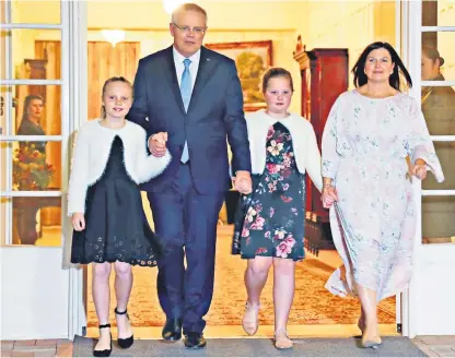  ??  ?? The new Australian prime minister Scott Morrison walks with his wife Jenny and daughters after his swearing-in ceremony in Canberra, Australia