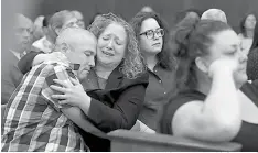  ?? Matt West/The Boston Herald via AP, Pool ?? Michael Sprinsky, far left, gets a hug from his sister, Laura Sprinsky, as a verdict of guilty is read for Michael P. McCarthy on Monday in Suffolk Superior Court in Boston. McCarthy was convicted of second-degree murder in the death of Bella Bond, a...