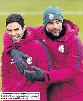  ?? Martin Rickett ?? > Manchester City manager Pep Guardiola (right) with his former assistant coach and now Arsenal boss Mikel Arteta
