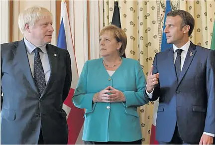  ??  ?? United Kingdom’s Boris Johnson with Germany’s Angela Merkel and France’s Emmanuel Macron at the EU meeting during the G7 summit in 2019.