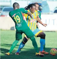  ?? RICARDO MAKYN/STAFF PHOTOGRAPH­ER ?? Humble Lion’s Gregory Hines (right) and his teammate Dwayne Holmes attempt to get the ball away from Waterhouse’s Jermaine Anderson (centre) in their Red Stripe Premier League encounter at the Drewsland Stadium yesterday. The game ended 1-1.