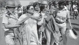  ??  ?? Police officials detain Congress Party supporters during a protest march towards Vidhansabh­a in Gandhinaga­r, on Monday, after a public meeting seeking justice for a rape victim in the western Kutch Districtof Gujarat.