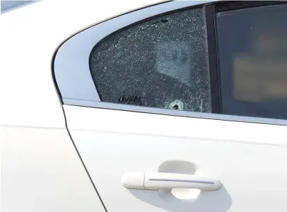  ?? ASHLEE REZIN GARCIA/SUN-TIMES ?? A bullet hole could be seen in the rear passenger window of a car in which a child was shot on Tuesday.