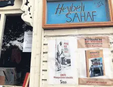  ??  ?? The entrance to the bookstore and a sign that reads “Heybeli Sahaf.”