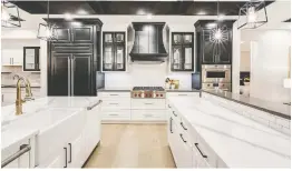  ?? SONA VISUAL ?? The Giovanni's black-and-white showstoppe­r kitchen includes double islands.