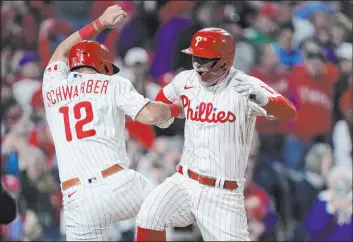  ?? Matt Rourke
The Associated Press ?? The Phillies’ Rhys Hoskins celebrates with Kyle Schwarber after clubbing a two-run homer during a 10-6 win against the Padres in the NLCS at Citizens Bank Park.