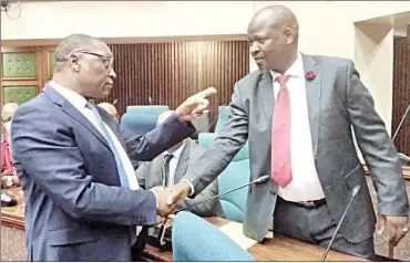  ?? Sabelo Majola) (Pics: ?? Minister of Tinkhundla Administra­tion and Developmen­t David ‘Cruiser’ Ngcamphala­la (L) in a conversati­on with Nkilongo MP Timothy Myeni in Parliament yesterday.