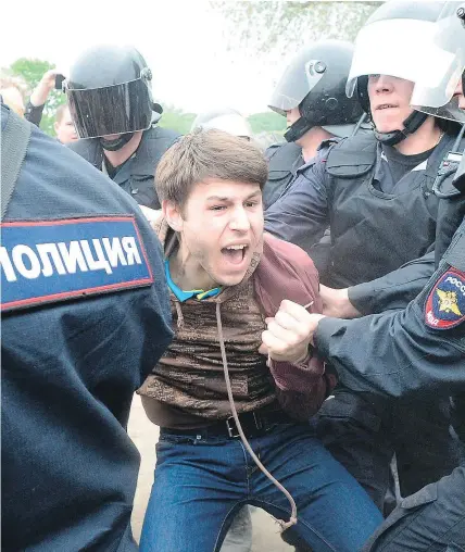  ?? — GETTY IMAGES ?? Russian police detain a participan­t in an unauthoriz­ed opposition rally in St. Petersburg on Monday. Over 200 people were detained at protests, said a Russian NGO.