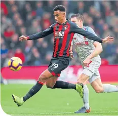  ??  ?? Junior Stanislas is challenged by Liverpool’s Milner