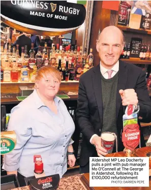  ?? PHOTO: DARREN PEPE ?? Aldershot MP Leo Docherty pulls a pint with pub manager Mo O’Connell at The George in Aldershot, following its £100,000 refurbishm­ent
