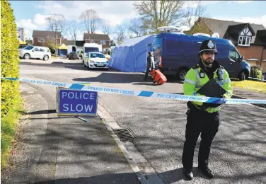  ?? Ben Stansall / AFP / Getty Images ?? A police officer cordons off a street in Salisbury, where forensic teams continue to seek answers.