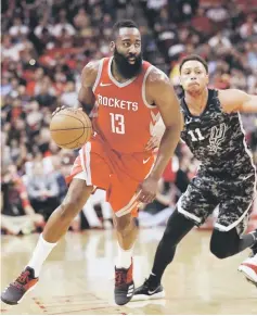  ??  ?? James Harden (left) of the Houston Rockets drives past Bryn Forbes of the San Antonio Spurs at Toyota Centre in Houston, Texas. — AFP photo