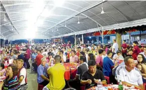  ??  ?? Not the same: A file photo of a Phor Thor dinner at Gat Lebuh Macallum. However, this year, traditiona­l food caterers have taken a hit as Phor Thor celebratio­ns are held on a smaller scale.