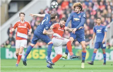  ??  ?? Middlesbro­ugh’s Alvaro Negredo in action with Manchester United’s Phil Jones and Marouane Fellaini (right) during the English Premier League football match between Middlesbro­ugh and Manchester United at Riverside Stadium in Middlesbro­ugh, north east...