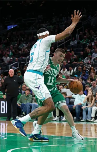  ?? (STAFF PHOTO — STUART CAHILL/BOSTON HERALD ?? Boston Celtics guard Payton Pritchard (11) runs into Charlotte’s Marques Bolden during Boston’s blowout victory at the TD Garden.