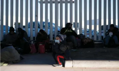  ??  ?? Asylum seekers at the El Chaparral crossing port in Tijuana, Mexico, 19 February 2021. ‘The USbegan allowing asylum seekers to cross its southern border for the first time since Trump’s ‘remain in Mexico’ initiative was launched in January 2019.’ Photograph: Guillermo Arias/ AFP/Getty Images