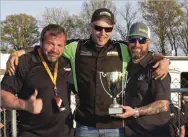  ??  ??  Lenny Reed and Donavan Harris (center) accept the second place UCC sled pull trophy from Alligator Diesel’s Chad Hall.