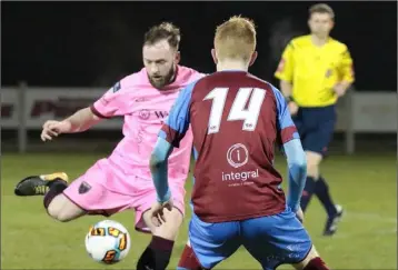  ??  ?? Mikey Byrne of Wexford F.C. takes aim as Drogheda United winger Mark Doyle closes in.