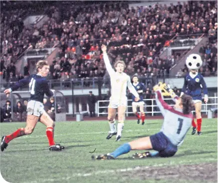  ??  ?? Kenny Dalglish lifts the ball over Jean-Marie Pfaff in 1982 for a goal many consider the finest of his career