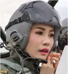  ??  ?? The Thai royal noble consort Sineenat Wongvajira­pakdi adjusting her pilot’s helmet in a military aircraft during a training session.