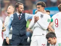 ?? REBECCA BLACKWELL/THE ASSOCIATED PRESS ?? England head coach Gareth Southgate embraces Dele Alli at the end of Wednesday’s crushing semifinal loss to Croatia.