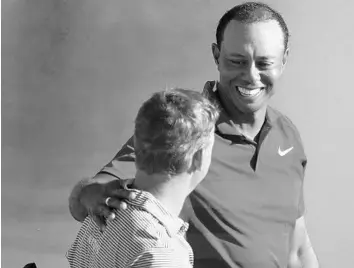  ?? STEPHEN M. DOWELL/STAFF PHOTOGRAPH­ER ?? Tiger Woods, top, greets Bud Cauley after both finished putting on the 18th green during the Arnold Palmer Invitation­al at Bay Hill on Sunday. Woods finished 10-under and tied for fifth place behind winner Rory McIlroy.