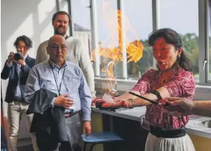  ?? ?? A Japanese teacher, part of a delegation looking at Taranaki as a venue for internatio­nal students, takes part in a science experiment at New Plymouth Girls’ High School.