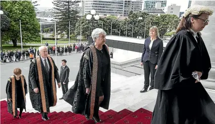  ?? PHOTO: KEVIN STENT/STUFF ?? Supreme Court judges, from left, Justice Ellen France, Justice Mark O’Regan and Chief Justice Dame Sian Elias, wearing their new ceremonial robes, are led up Parliament steps by High Court registrar Jane Penney.