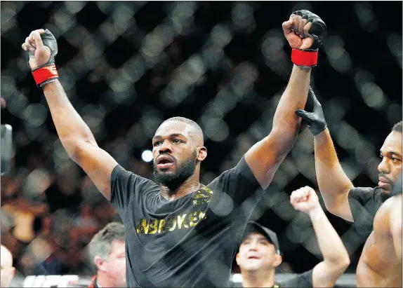 ?? — THE ASSOCIATED PRESS FILES ?? Jon Jones, seen celebratin­g his light heavyweigh­t title victory over Daniel Cormier last January, has been suspended and will sit out as Cormier and Anthony Johnson battle May 23 for the vacant light-heavy crown.