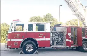  ?? TIMES photograph by Annette Beard ?? Thanks to the diligence of Danny Smith of Copy Cat Printing and Graphics LLC, the new Pea Ridge Fire Department ladder truck was “stickered” in time to park the truck beside the highway for the memorial procession­al tribute to deceased Rogers Fire Capt. Mike Cerasale in May, just days after the department received the truck from Rogers. The truck was presented to city officials at the July City Council meeting.