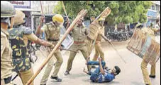  ?? PTI FILE ?? Police personnel baton charge at a protestor demanding the closure of Sterlite Copper unit in Tuticorin in May.