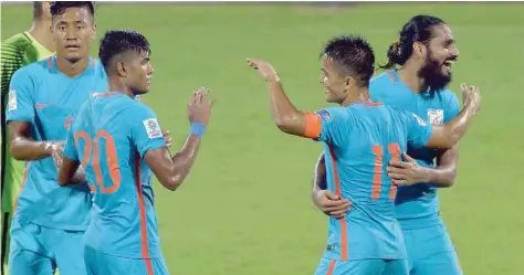  ?? — AFP ?? Indian captain Sunil Chhetri (second right) celebrates his team’s 4-1 victory during the 2019 AFC-Asian Cup qualifying match against Macau held at the Kanteerava Stadium in on Wednesday.