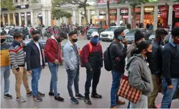  ?? — G.N. JHA ?? Passengers stand in queue to enter a Metro station in New Delhi on Wednesday.