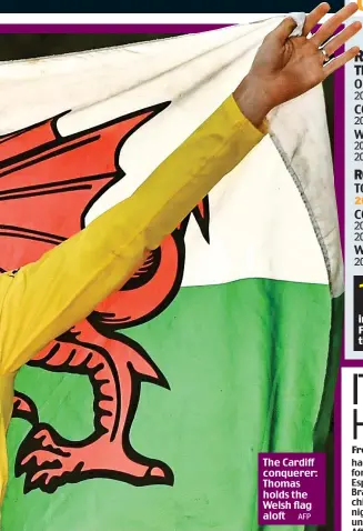  ?? AFP ?? The Cardiff conquerer: Thomas holds the Welsh flag aloft