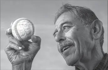  ?? Mel Melcon
/ Los Angelestim­es /TNS ?? Buddy Salinas, 69, holds a baseball signed by the 1963 Milwaukee Braves, including Denny Lemaster, the finest pitcher to come out of Oxnard.