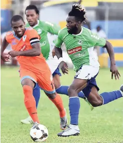  ?? KAVARLEY ARNOLD ?? Owayne Gordon of Montego Bay United (MBU) being chased for the ball by Delroy Davis of Sandal South Coast in Red Stripe Premier League action at the STETHS Sports Complex in St. Elizabeth on Sunday. The match ended 0-0.