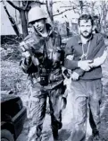  ?? The Associated Press ?? A Yugoslav soldier leads a captured Croatian guardsman in 1991.