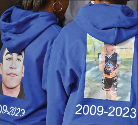  ?? CHRIS CHRISTO — BOSTON HERALD ?? Children wear sweatshirt­s with photos of shooting victim Tyler Lawrence during his celebratio­n of life. He was just 13.