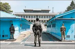  ?? YONHAP/EPA ?? U.S. and South Korean soldiers stand guard Thursday at the inter-Korean truce village of Panmunjom ahead of the historic talks between the Koreas next week at the village.