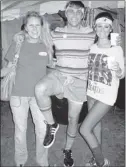  ??  ?? Brandy Marek (left) and Josh and Krista Robinson relived the 1980s at the “Totally Awesome ’80s Night” Partners in Preservati­on and Taste of the Town Party.