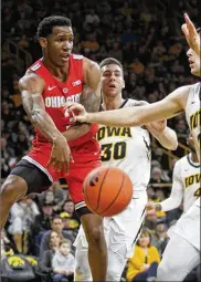  ?? MATTHEW HOLST / GETTY IMAGES ?? Ohio State guard C.J. Jackson looks for an open teammate under the basket Saturday against Iowa. In his first game coming off the bench after 39 straight starts, Jackson had 10 points and three assists.