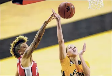  ?? Charlie Neibergall / Associated Press ?? Iowa forward Logan Cook drives to the basket past Ohio State guard Rikki Harris.
