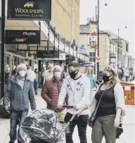  ??  ?? THE NEW NORMAL: Calderdale shoppers sport face masks and coverings, in accordance with new Government guidelines.