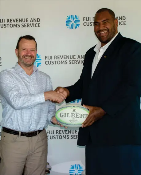  ?? ?? Fiji Revenue and Customs Service chief executive officer Mark Dixon congratula­tes his Principal Auditor/Team Leader Tevita Tuiloa on his appointmen­t as director for Fiji Rugby Union.