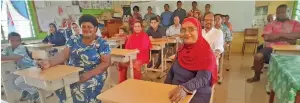  ?? Photo: Mereleki Nai ?? Parents, teachers and donors with the new school desks inside the Year 8 classroom at Rahmatulla­h Khan Memorial School.
