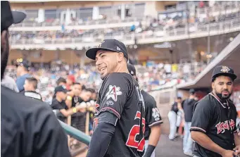  ?? ROBERTO E. ROSALES/JOURNAL ?? Albuquerqu­e outfielder Noel Cuevas jokes around with teammates prior to Saturday night’s home game. He is happy that family in Puerto Rico will be able to see him play in Wednesday’s Triple-A All-Star Game.