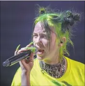  ?? Allen J. Schaben Los Angeles Times ?? UBIQUITOUS NEON GREEN is the latest trademark of Billie Eilish, who gives pop a goth sensibilit­y.