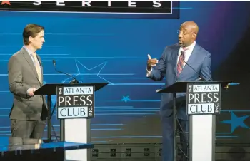  ?? BEN GRAY/AP ?? Libertaria­n challenger Chase Oliver, left, and incumbent Democratic Sen. Raphael Warnock square off in a debate Oct. 16 in Atlanta.