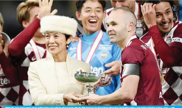  ?? — AFP ?? TOKYO: File photo shows Andres Iniesta of Vissel Kobe poses with the winners trophy after the 99th Emperor’s Cup final between Vissel Kobe and Kashima Antlers at the National Stadium in Tokyo, Japan.