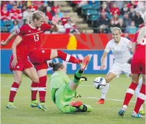  ?? JEFF McINTOSH/THE CANADIAN PRESS ?? Canadian goalie Erin McLeod, centre, makes a save against New Zealand during Women’s World Cup action in Edmonton, Thursday.